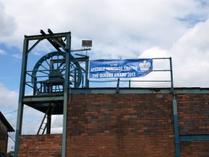 The old mine winding gear, with our banner announcing our Queens Award for Voluntary Service